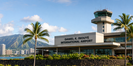 Daniel K. Inouye International Airport terminal and control tower under tropical skies
